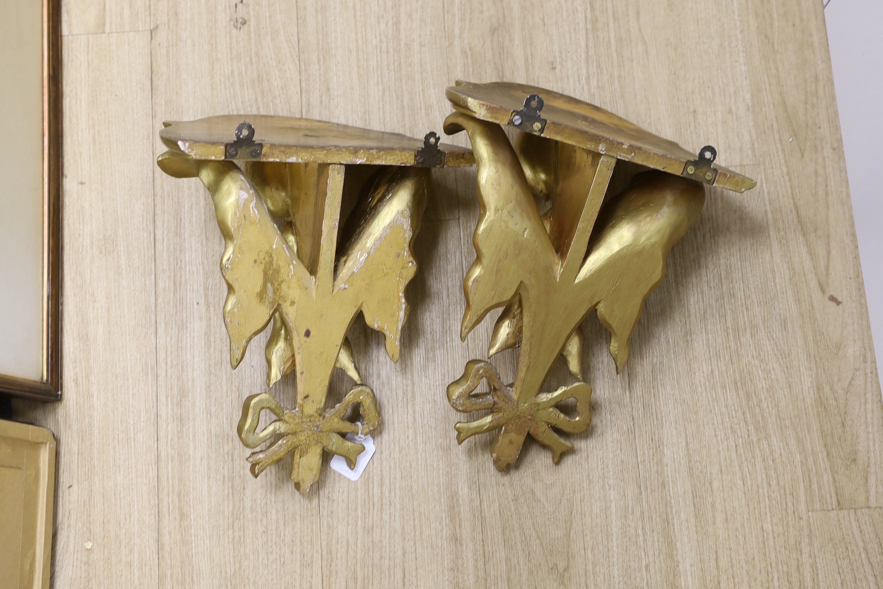 A pair of decorative ivy carved giltwood wall brackets, 40cms high